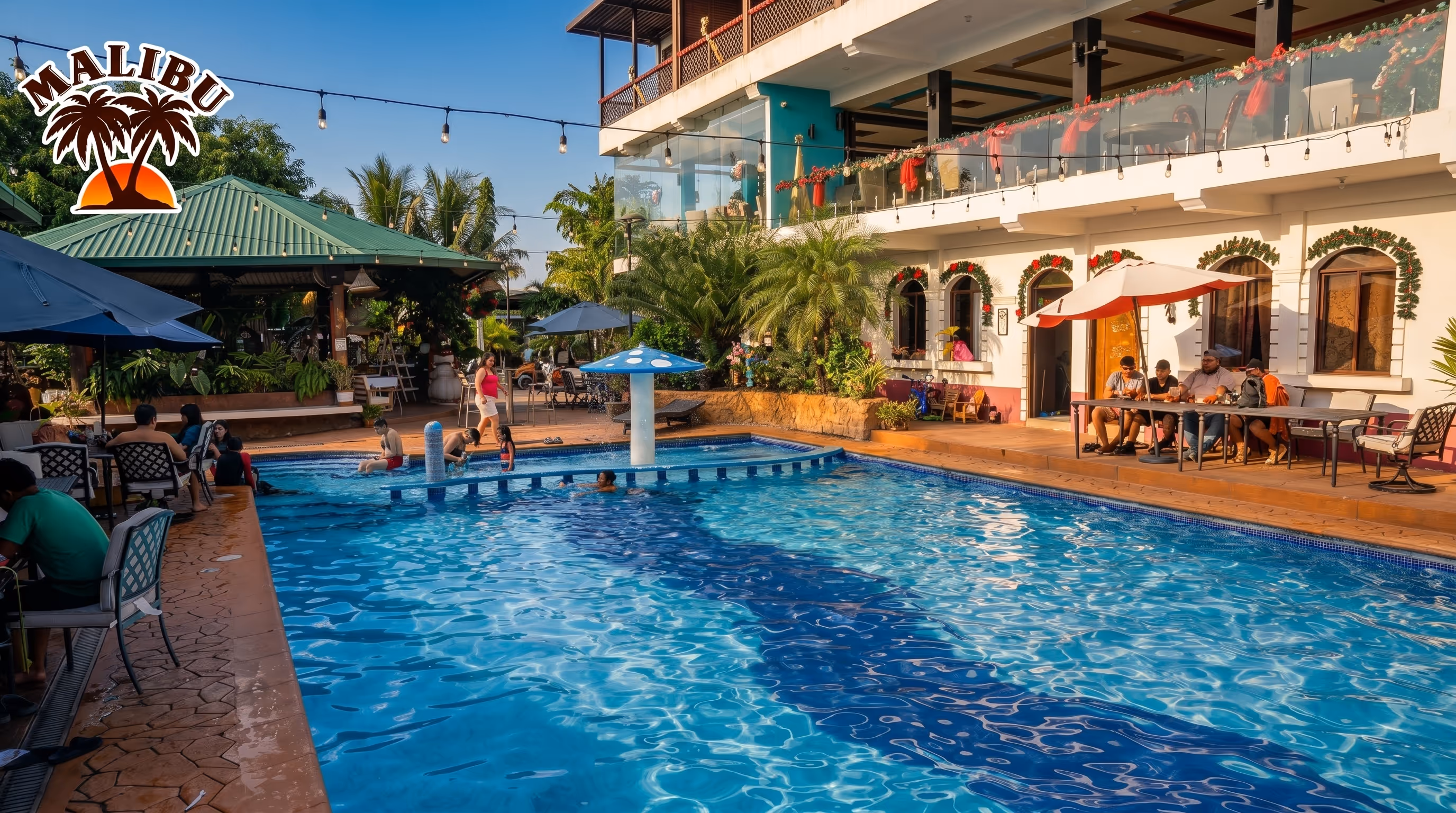 Fachada blanca de Hotel Malibu con habitaciones de balcón privado y palmeras al atardecer